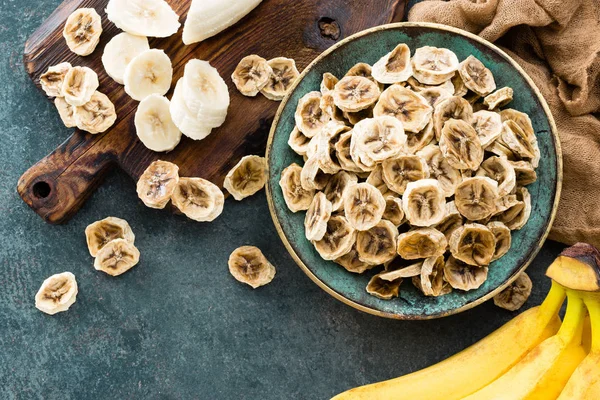 Dried banana chips and fresh bananas