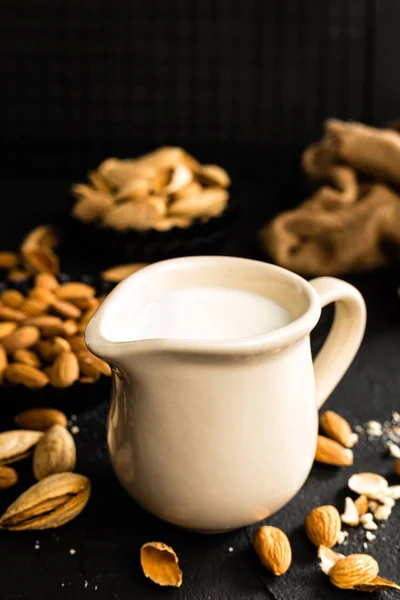 Homemade almond milk in jug. Almond milk and almonds