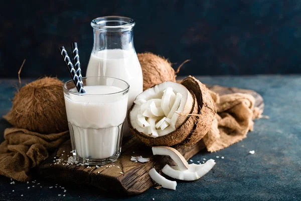 Fresh coconut milk in glass and bottle, vegan non dairy healthy drink