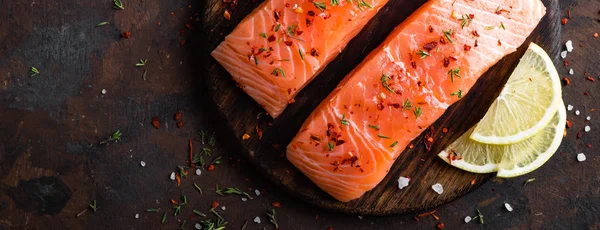 Fresh salmon fish fillet on wooden board