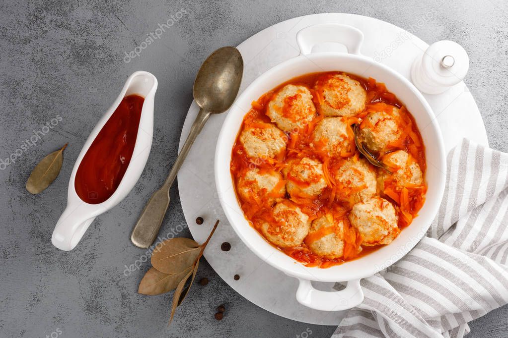 Fish meatballs in tomato sauce with carrot, top view