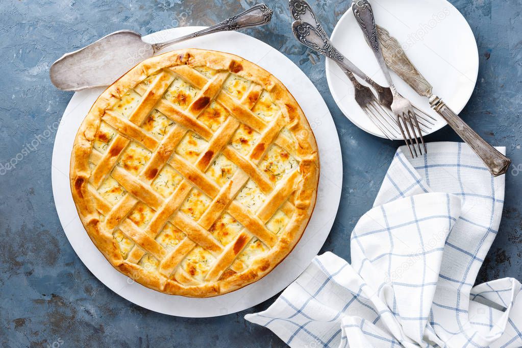 Pie with salted soft cheese and greens