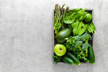 Sağlıklı vejetaryen gıda kavramı arka plan, taze yeşil gıda seçimi için detoks diyet, çiğ brokoli, elma, salatalık, ıspanak, bezelye, kuşkonmaz, avokado, kireç, Mısır salata ve mung fasulye Yukarıdan görüş, yat