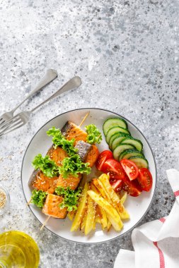 Fırında patates, taze salatalık ve domates ile şiş üzerinde ızgara somon kebap