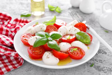 Caprese salatası. Mozzarella peynirli salata taze domates, fesleğen yaprağı ve zeytinyağı. İtalyan yemeği.