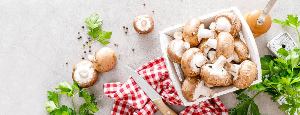 Raw mushrooms champignons on white background, cooking fresh champignons. Banner