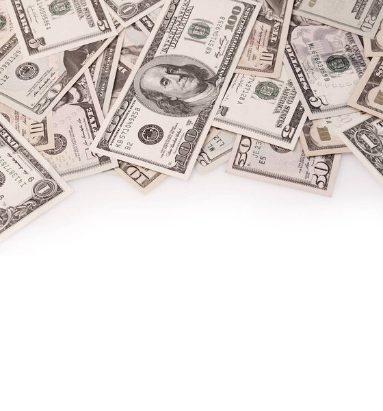 Closeup of assorted American banknotes on plain background