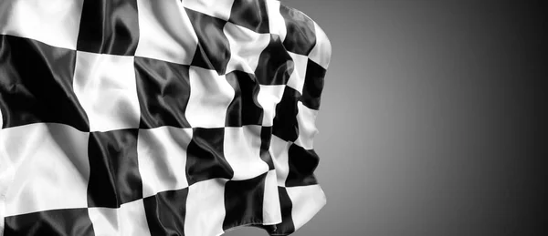 Checkered black and white flag on grey background. Copy space