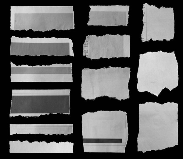 Pieces of torn newspaper on black background