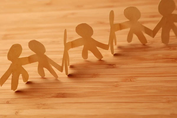 Paper chain team holding hands — Stock Photo, Image