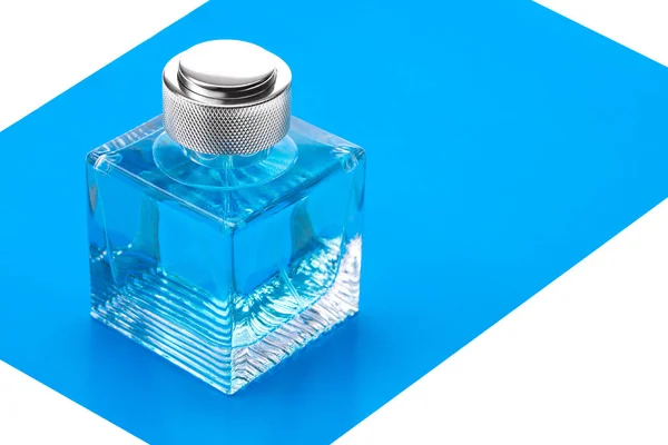 A bottle of perfume on a blue background. — Stock Photo, Image