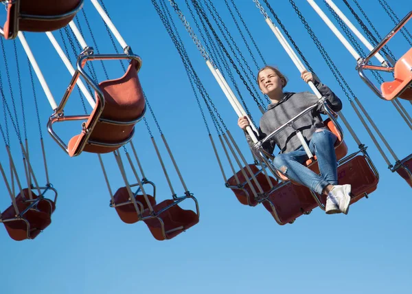 The girl on the swing. Attraction in the park. — Stock Photo, Image