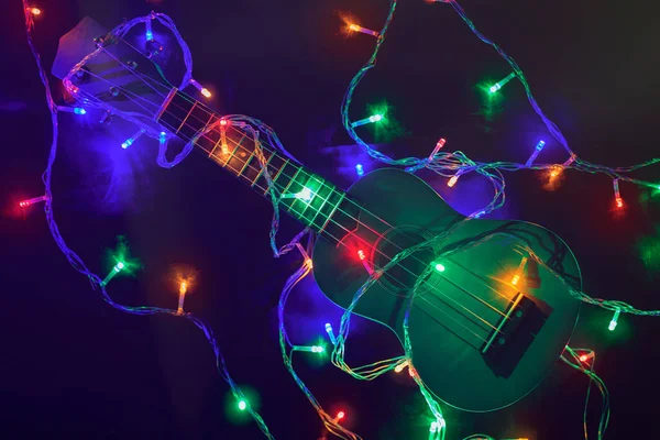 Guitar on a background of colored lights. Flashing lights of a g — Stock Photo, Image