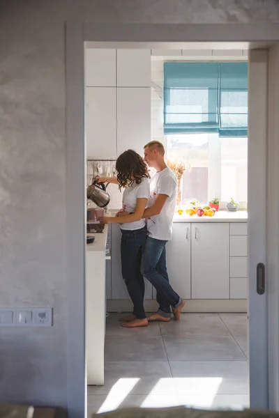 Beautiful young couple in love in the kitchen