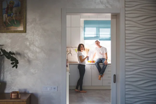 Beautiful young couple in love in the kitchen