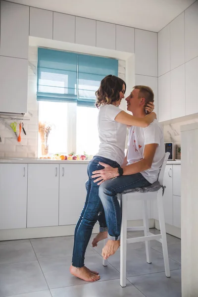 Beautiful young couple in love in the kitchen