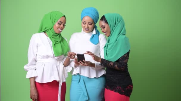 Three young African Muslim women together against chroma key with green background — Stock Video