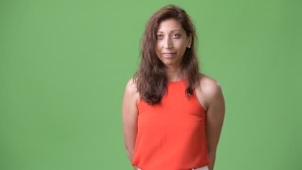 Beautiful businesswoman against green background — Stock Video