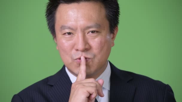 Maturo giapponese uomo d'affari contro verde sfondo — Video Stock