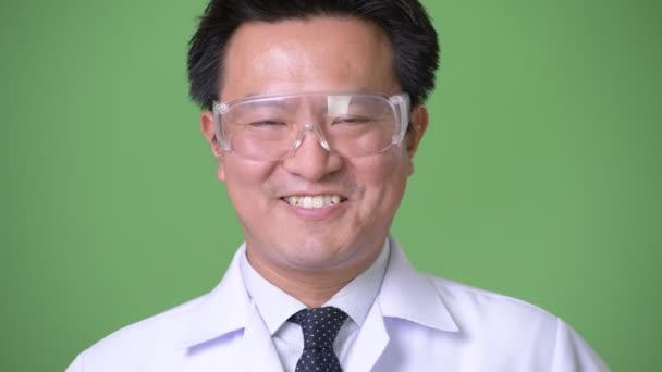 Mature Japanese man doctor wearing protective glasses — Stock Video