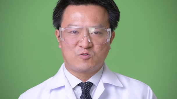 Mature Japanese man doctor wearing protective glasses — Stock Video