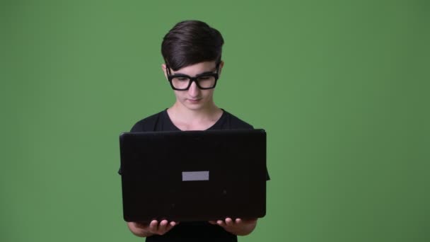 Young handsome Iranian teenage boy against green background — Stock Video