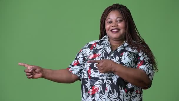 Overgewicht mooie Afrikaanse vrouw tegen groene achtergrond — Stockvideo