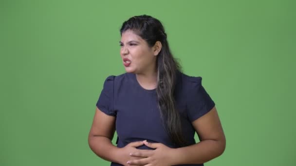 Joven mujer de negocios india hermosa con sobrepeso contra fondo verde — Vídeos de Stock
