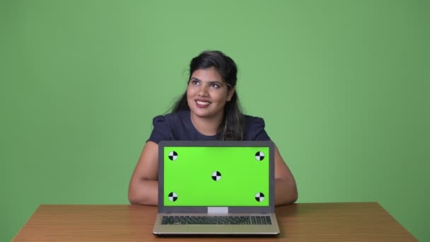 Young overweight beautiful Indian businesswoman against green background — Stock Video