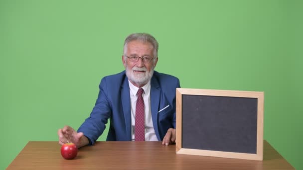 緑の背景を持つハンサムなシニアひげそりのビジネスマン — ストック動画