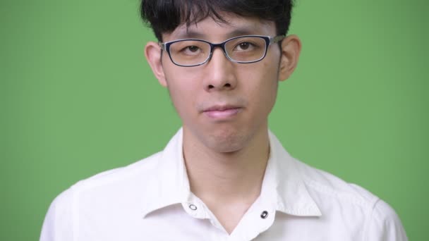 Foto dianteira de jovem empresário asiático contra fundo verde — Vídeo de Stock