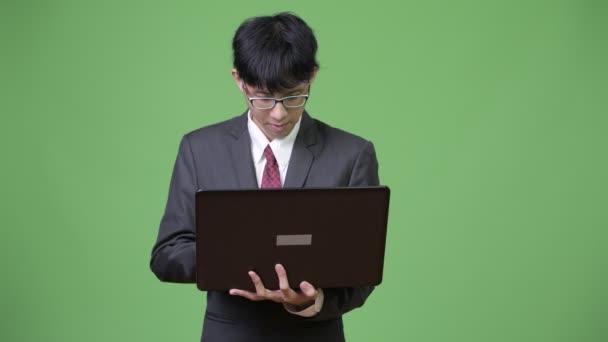 Young Asian businessman using laptop — Stock Video