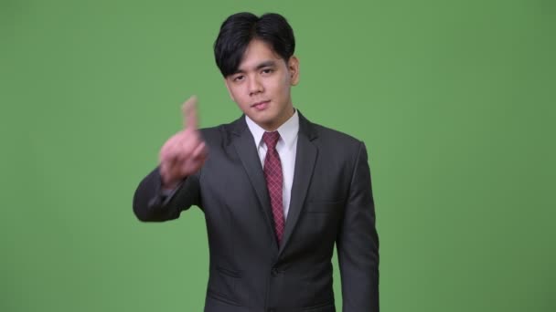 Young handsome Asian businessman gesturing to stop — Stock Video