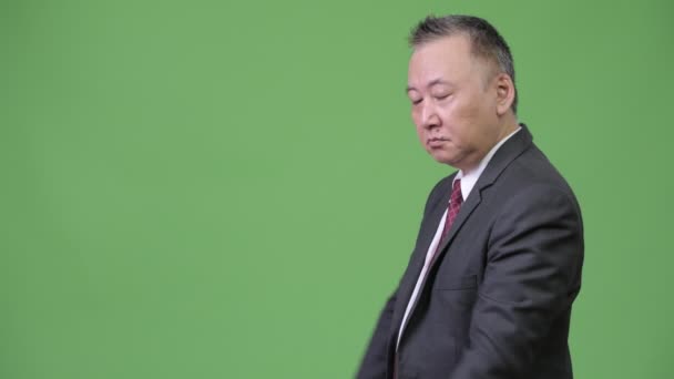 Érett japán üzletember mutatja, valami — Stock videók