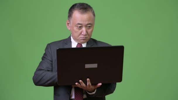 Mogna japansk affärsman arbetar med laptop — Stockvideo