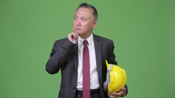 Mature Japanese businessman as engineer thinking — Stock Video