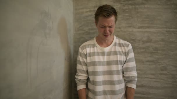 Young sad Scandinavian man crying while covering face at home — Stock Video