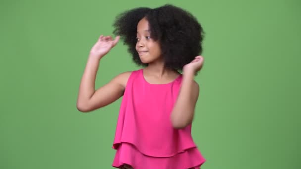 Ung Söt afrikansk flicka med Afro hår visar något — Stockvideo