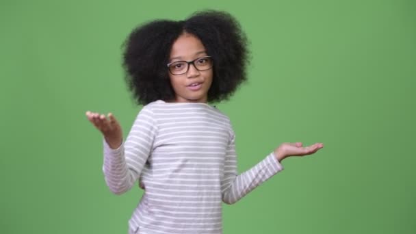 Young cute African girl with Afro hair talking to camera — Stock Video