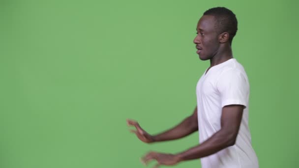 Young African man resisting something as concept — Stock Video