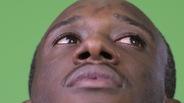 Close up shot of young African man thinking while looking up — Stock Video