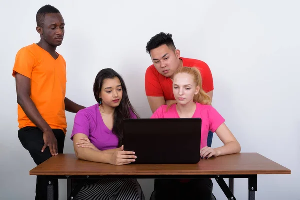 Studio shot of diverse group of multi ethnic friends using lapto — Stock Photo, Image