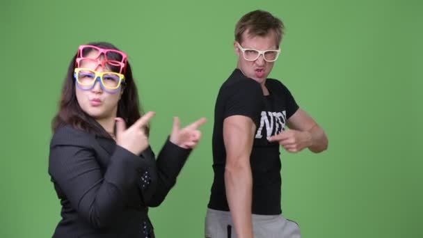 Mature Asian businesswoman and young Scandinavian nerd man together — Stock Video