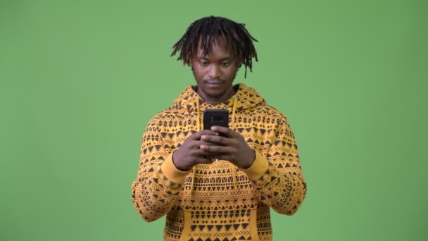 Young handsome African man using phone — Stock Video