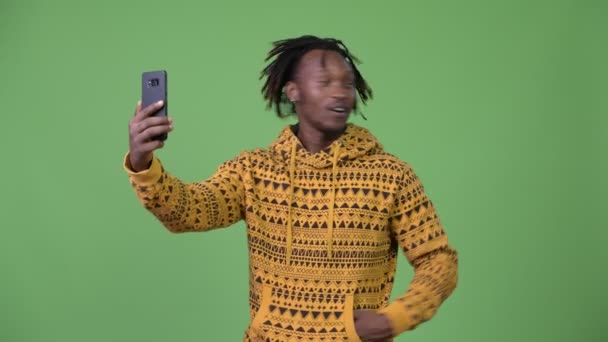 Молодой красивый африканский мужчина звонит и показывает телефон — стоковое видео