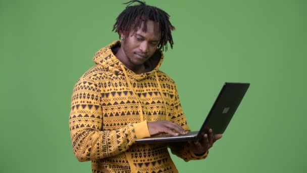 Joven hombre africano guapo usando portátil — Vídeos de Stock