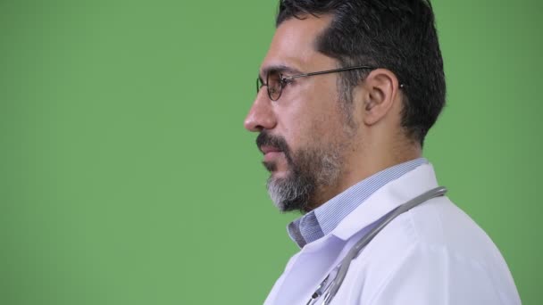 Profile view of handsome Persian bearded man doctor — Stock Video