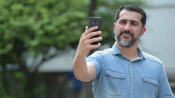 Bonito homem barbudo persa tomando selfie nas ruas ao ar livre — Vídeo de Stock