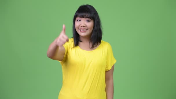 Beautiful happy Asian woman giving thumbs up — Stock Video