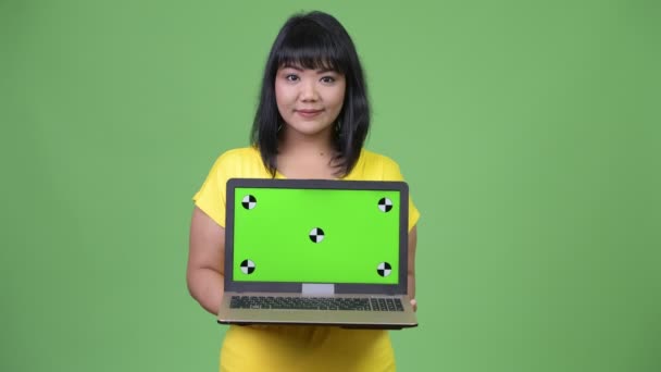 Mulher asiática feliz bonita mostrando laptop — Vídeo de Stock